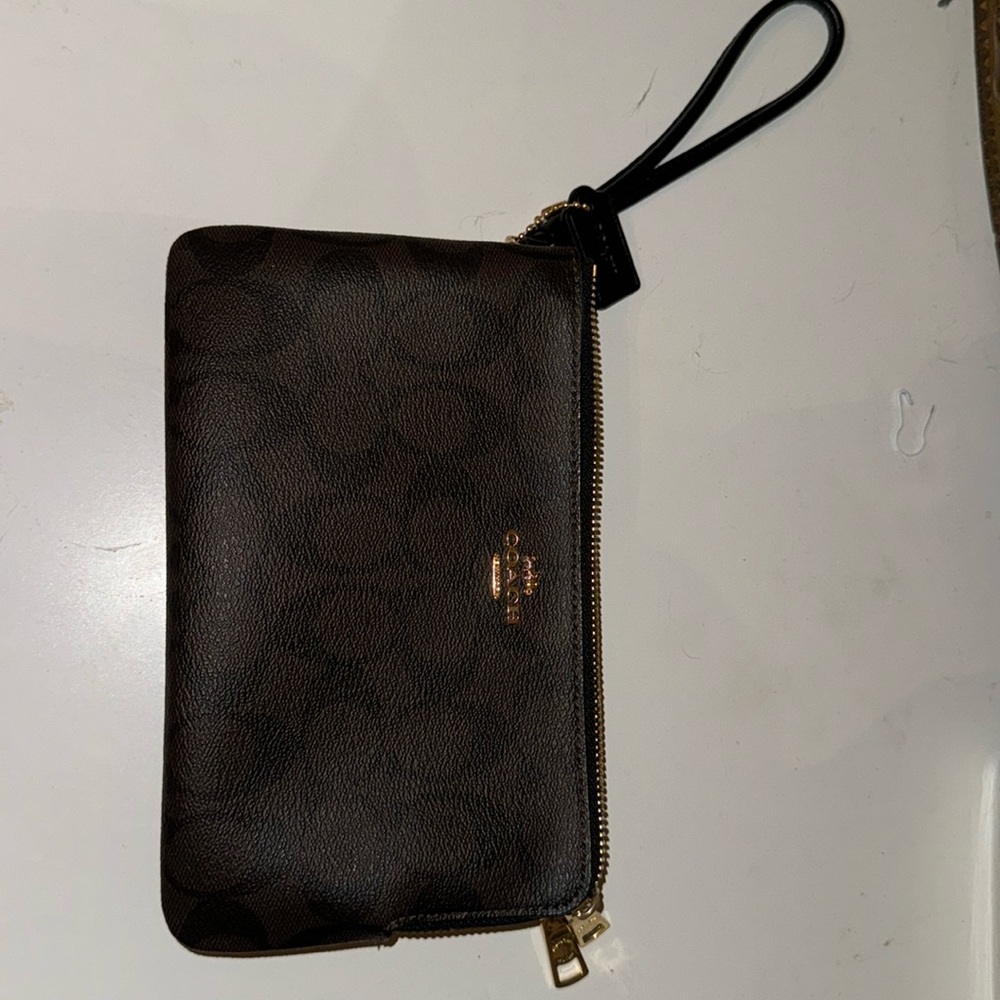 Coach wristlet with original coach monogram print. Never been used.